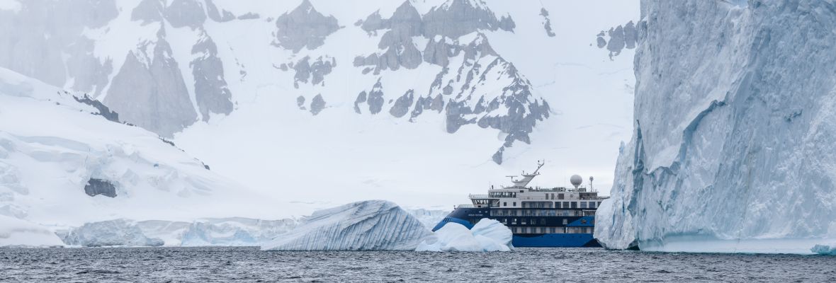 Ocean Victory, dwarfed by giant Antarctic icebergs
