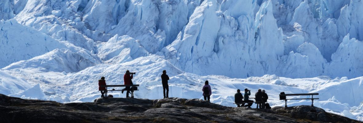 Visitors absorbing the majesty of Ilulissat Icefjord, Greenland Visitors absorbing the majesty of Ilulissat Icefjord, Greenland