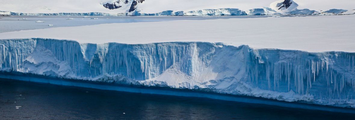 Zodiac cruising at a tabular iceberg