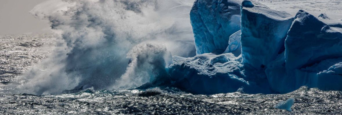 Storm waves hit an iceberg in the Gerlache Strait, Antarctica