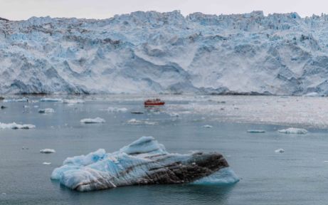 Fishing boat sailing next to a glacier, Eqip Sermia